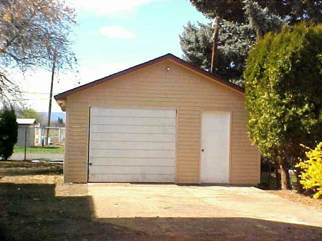3112 South Wiley Road Yakima, WA 98903 - Photo 7 of 7 a view of yellow house with a yard and potted plants