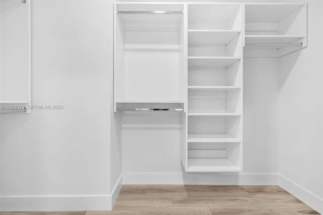 a spacious bathroom with a double vanity and a shower