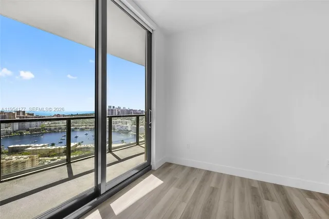 a living room with furniture and a floor to ceiling window