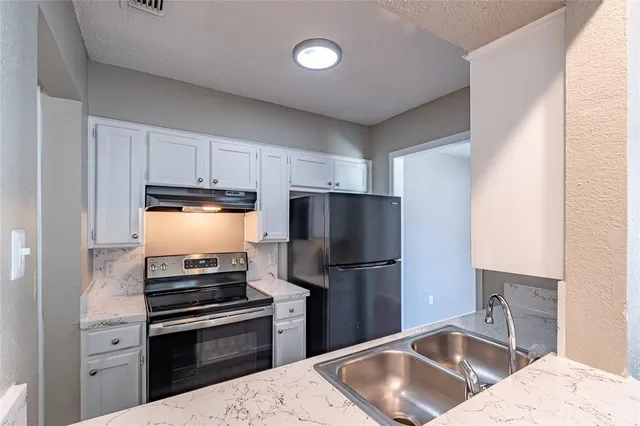 a kitchen with a sink stove and refrigerator