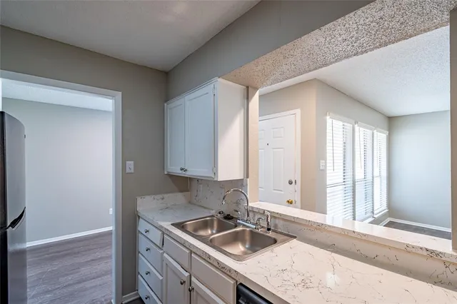 a kitchen with a sink and cabinets