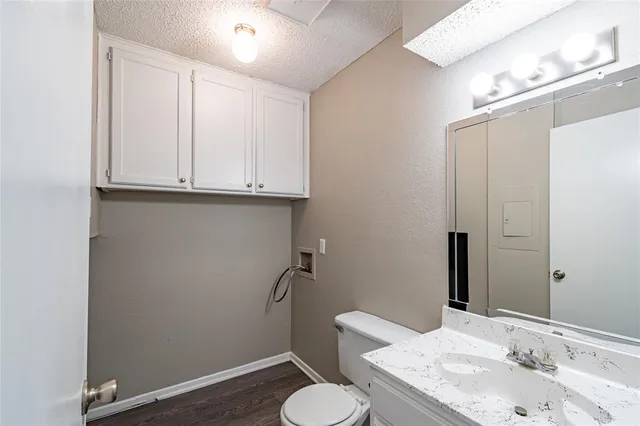 a bathroom with a sink toilet and mirror