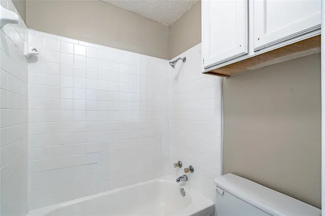 a bathroom with a bathtub and shower