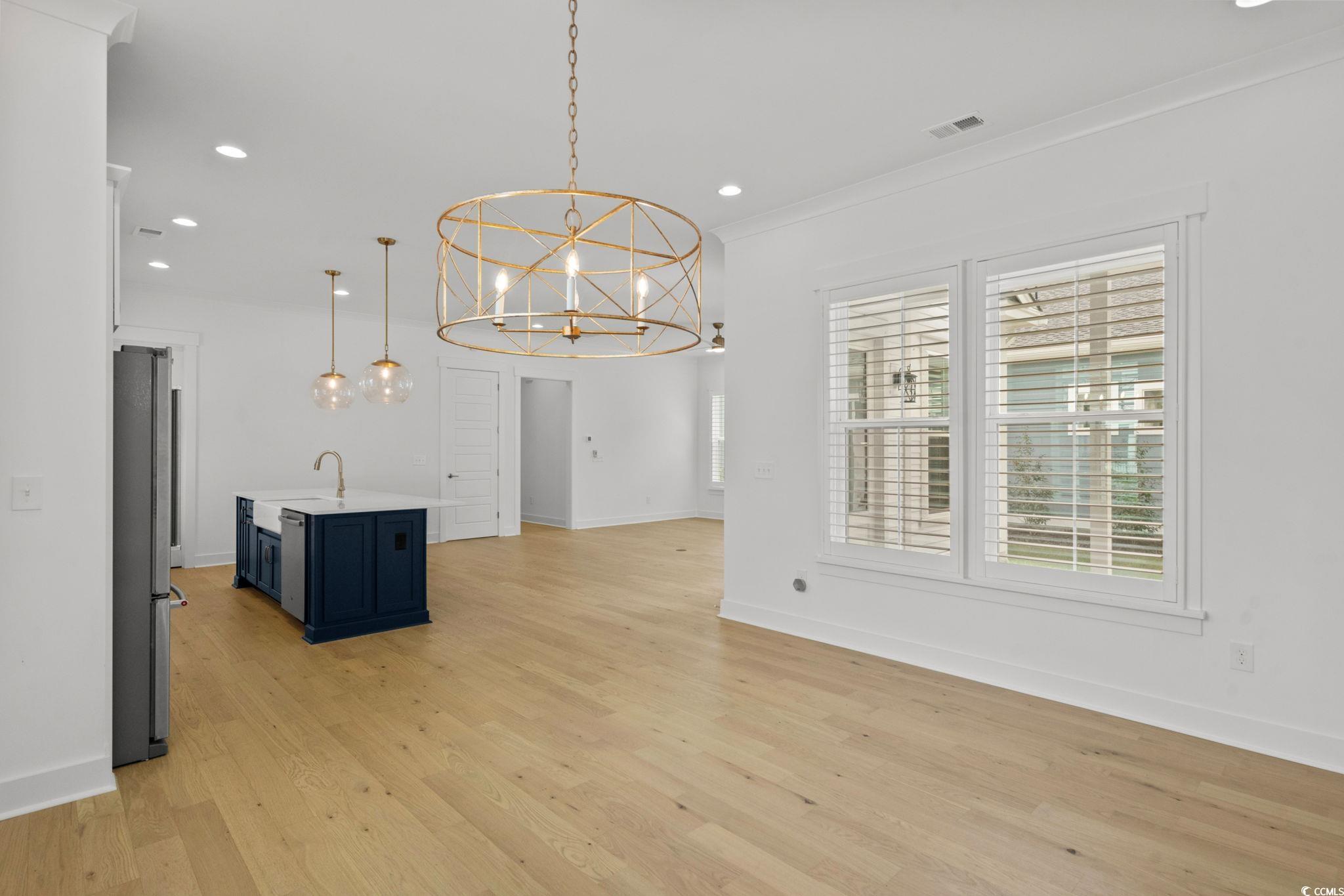 477 Ayrhill Loop Myrtle Beach, SC 29588 - Photo 10 of 39 Unfurnished dining area featuring recessed lighting, light wood finished floors, a chandelier, and crown molding