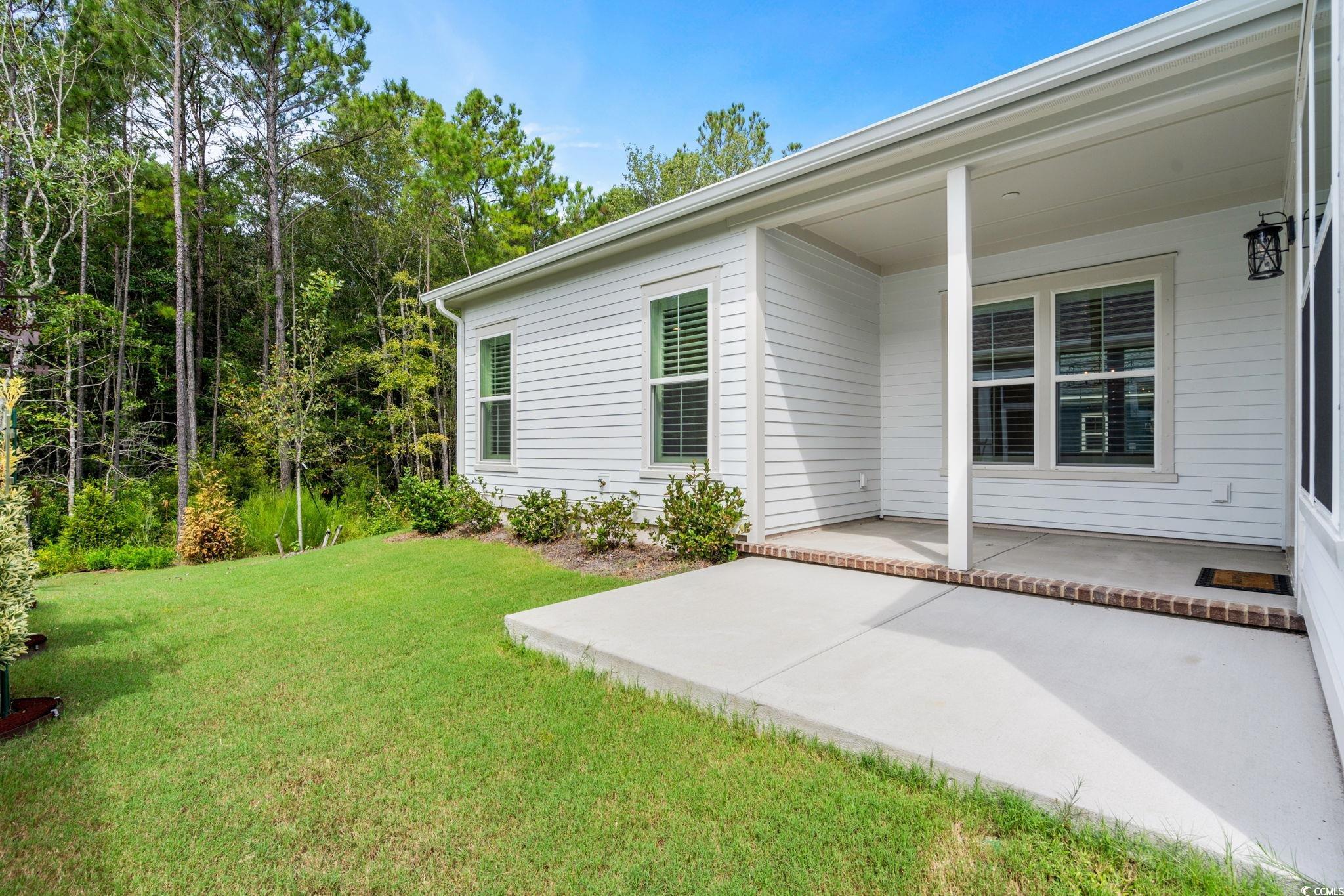 477 Ayrhill Loop Myrtle Beach, SC 29588 - Photo 18 of 39 View of grassy yard featuring a patio area