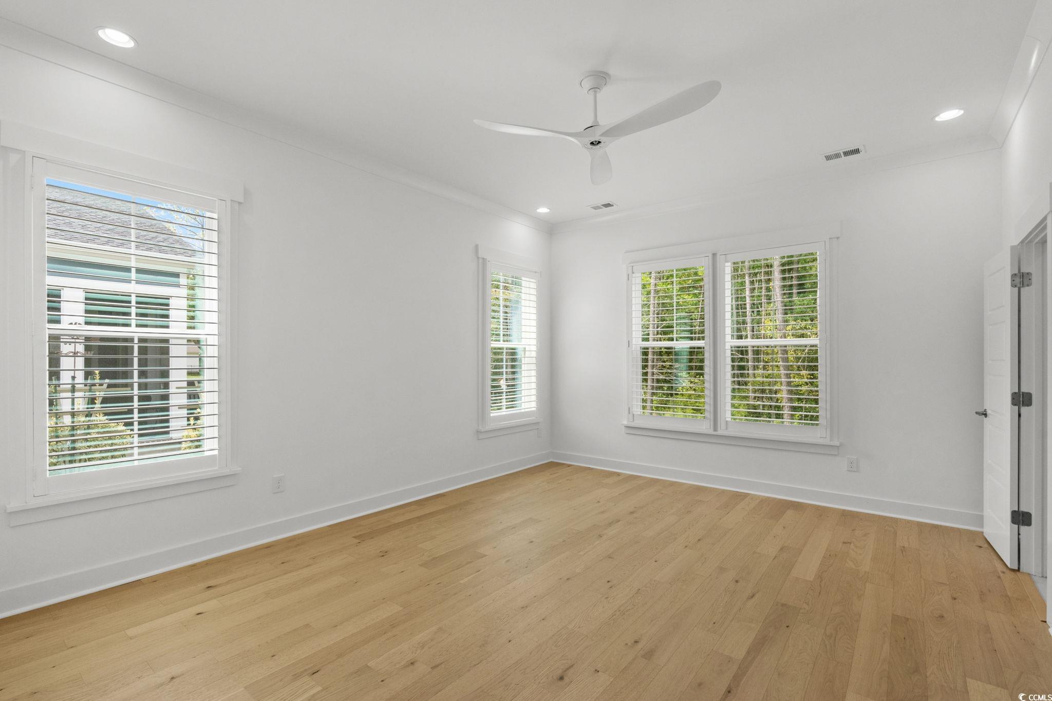 477 Ayrhill Loop Myrtle Beach, SC 29588 - Photo 20 of 39 Empty room featuring light wood-type flooring, recessed lighting, ornamental molding, and a ceiling fan