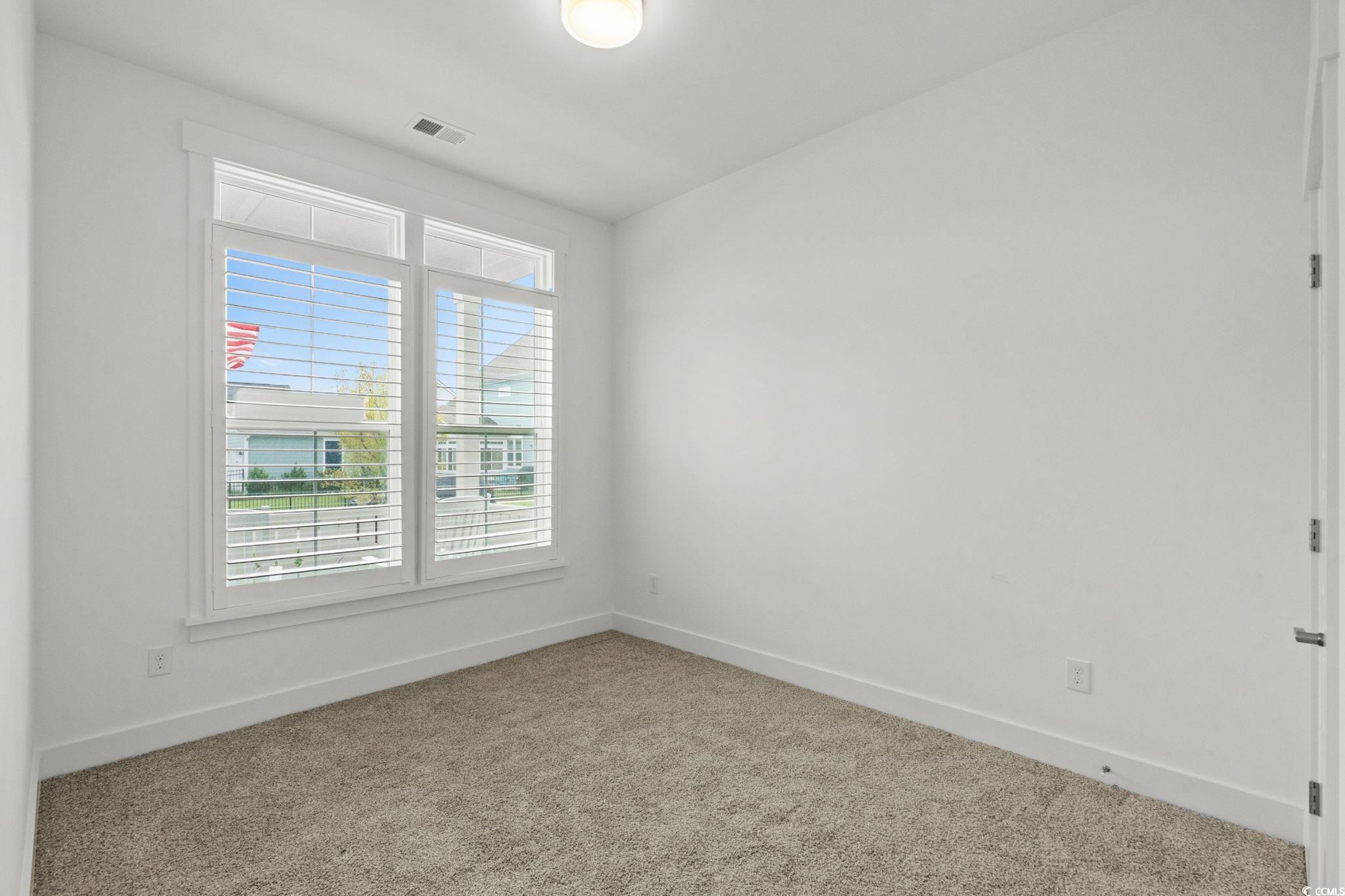477 Ayrhill Loop Myrtle Beach, SC 29588 - Photo 25 of 39 Carpeted empty room with baseboards