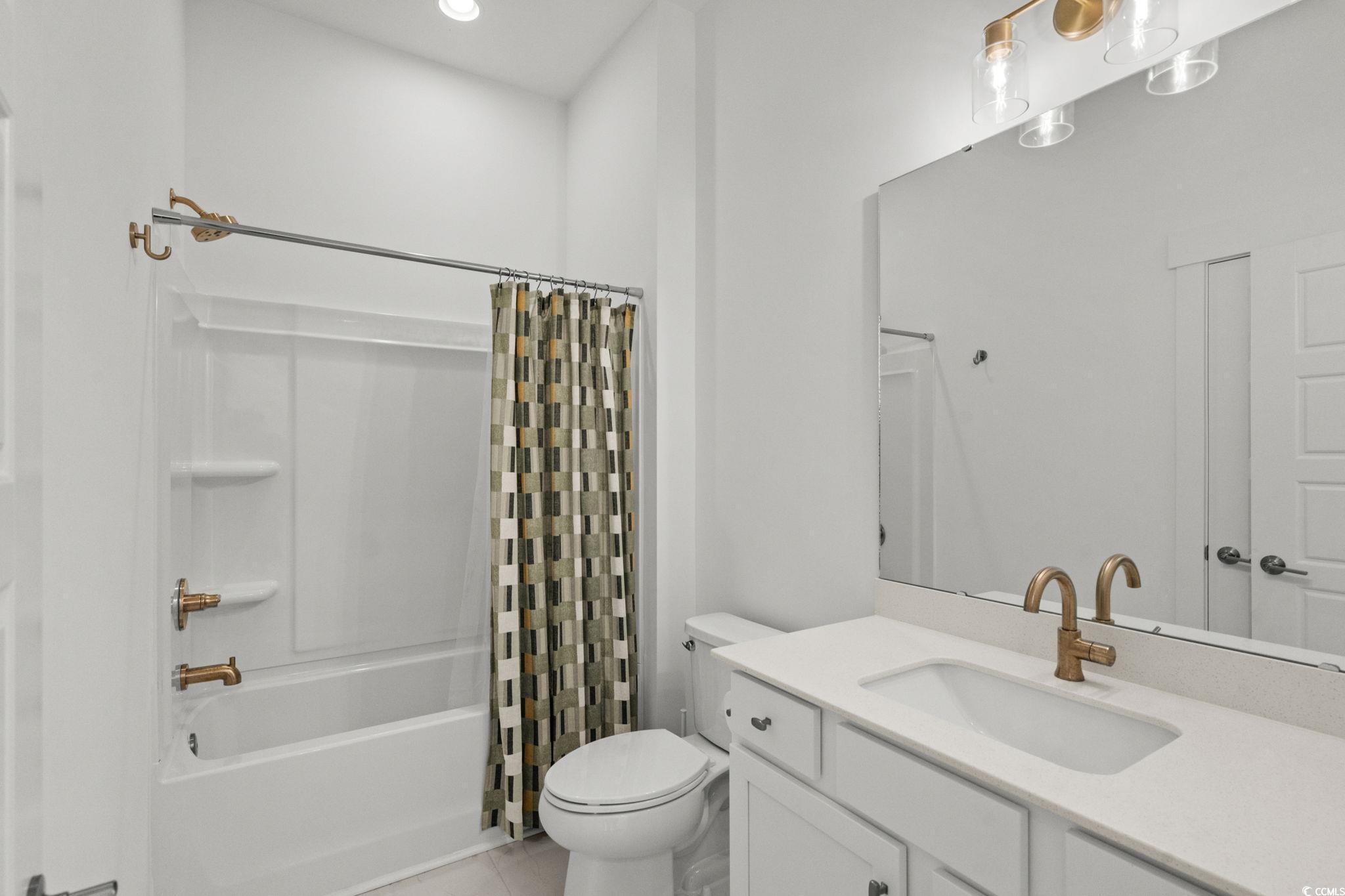 477 Ayrhill Loop Myrtle Beach, SC 29588 - Photo 26 of 39 Bathroom with shower / bathtub combination with curtain, vanity, and light tile patterned floors