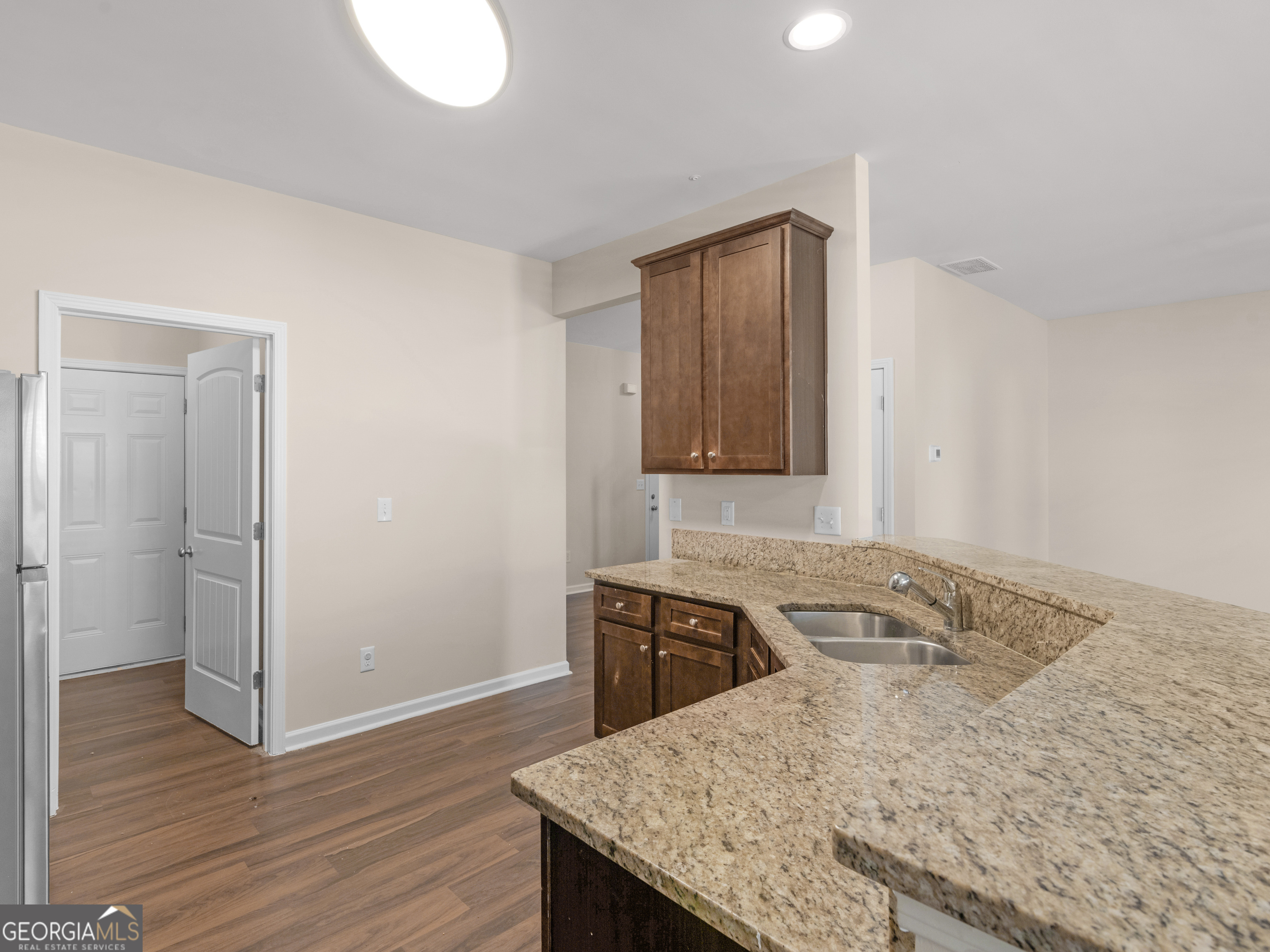 1244 Faye Court McDonough, GA 30253 - Photo 12 of 35 a kitchen with a sink a stove and wooden floor