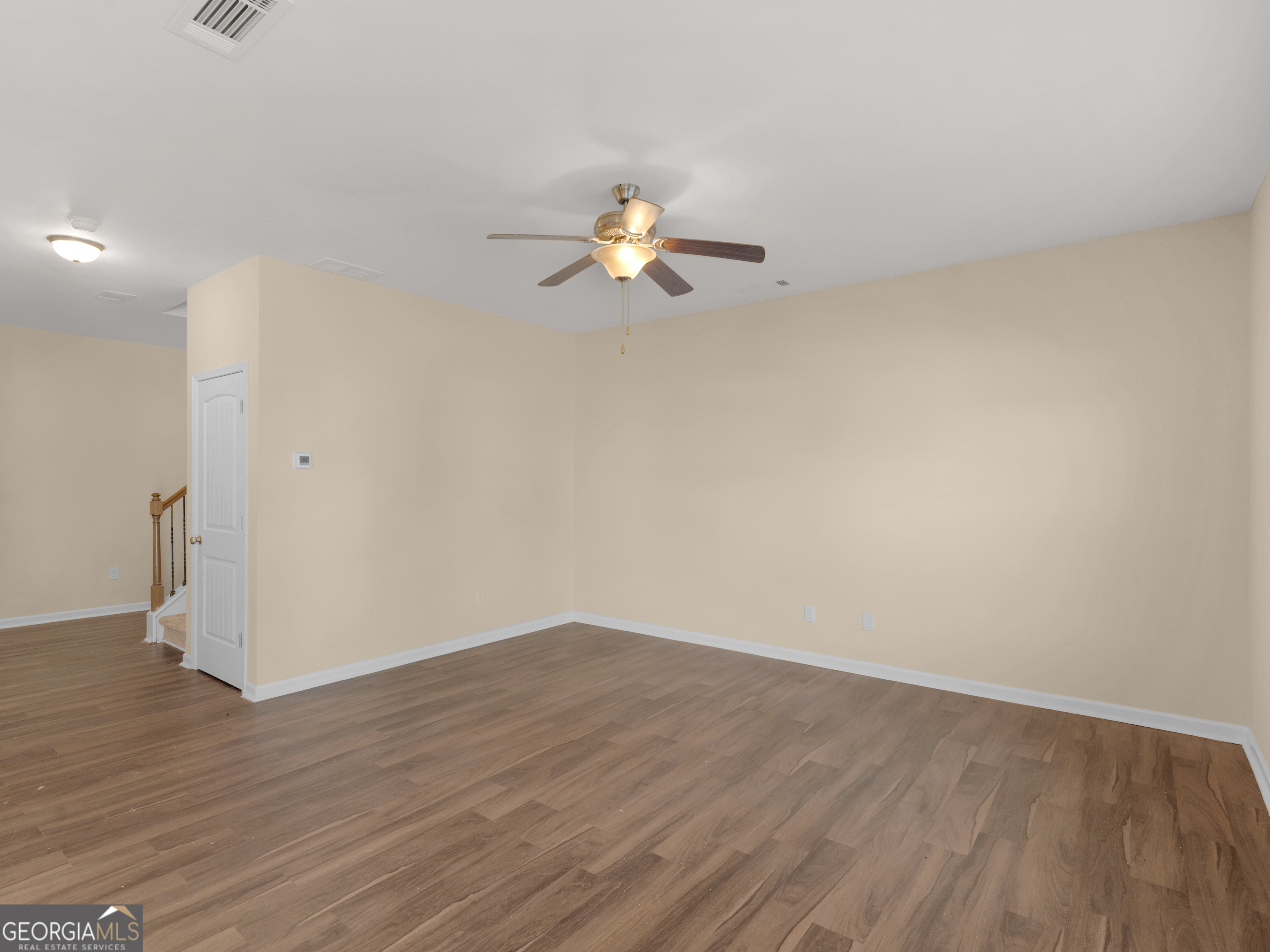 1244 Faye Court McDonough, GA 30253 - Photo 2 of 35 a view of a room with wooden floor and a ceiling fan