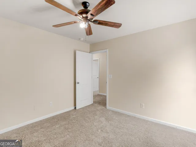 an empty room with a fan and a fan