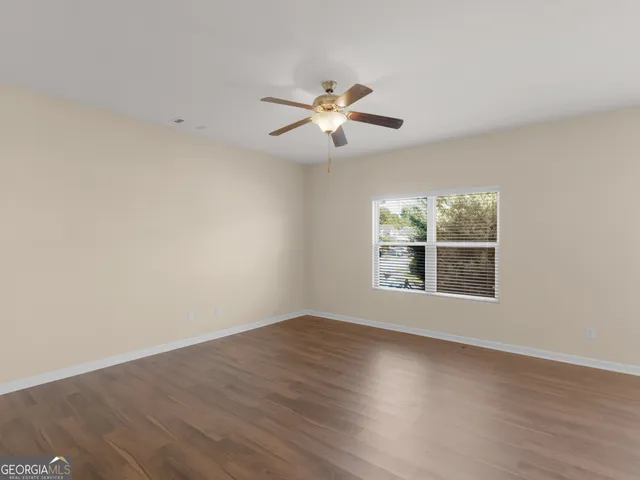 wooden floor in an empty room with a window
