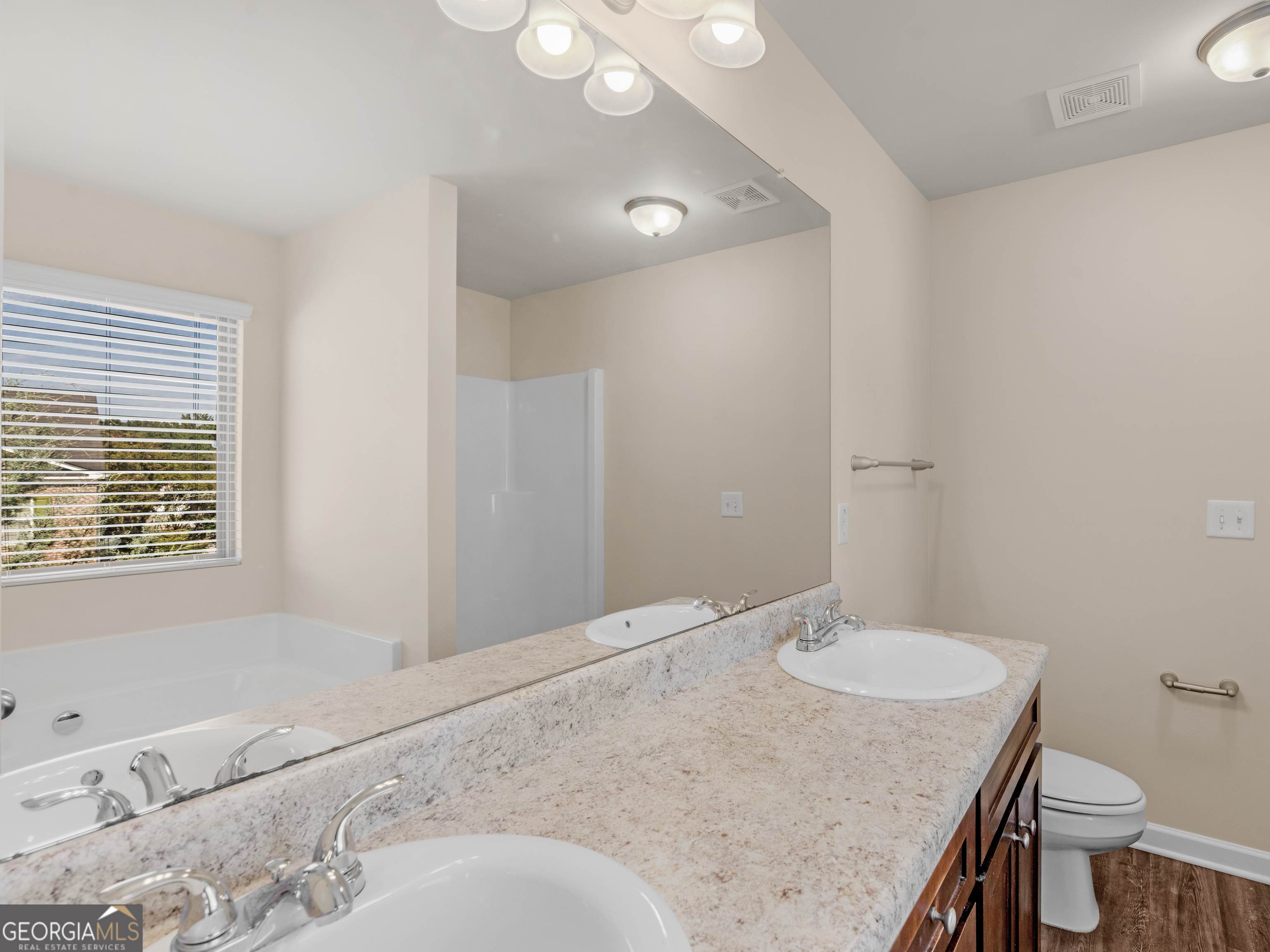 1244 Faye Court McDonough, GA 30253 - Photo 32 of 35 a bathroom with a granite countertop sink and a mirror