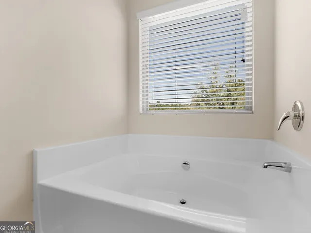a white bath tub sitting next to a window
