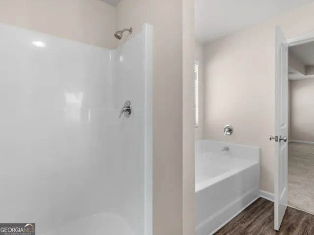 a bathroom with a bathtub and shower