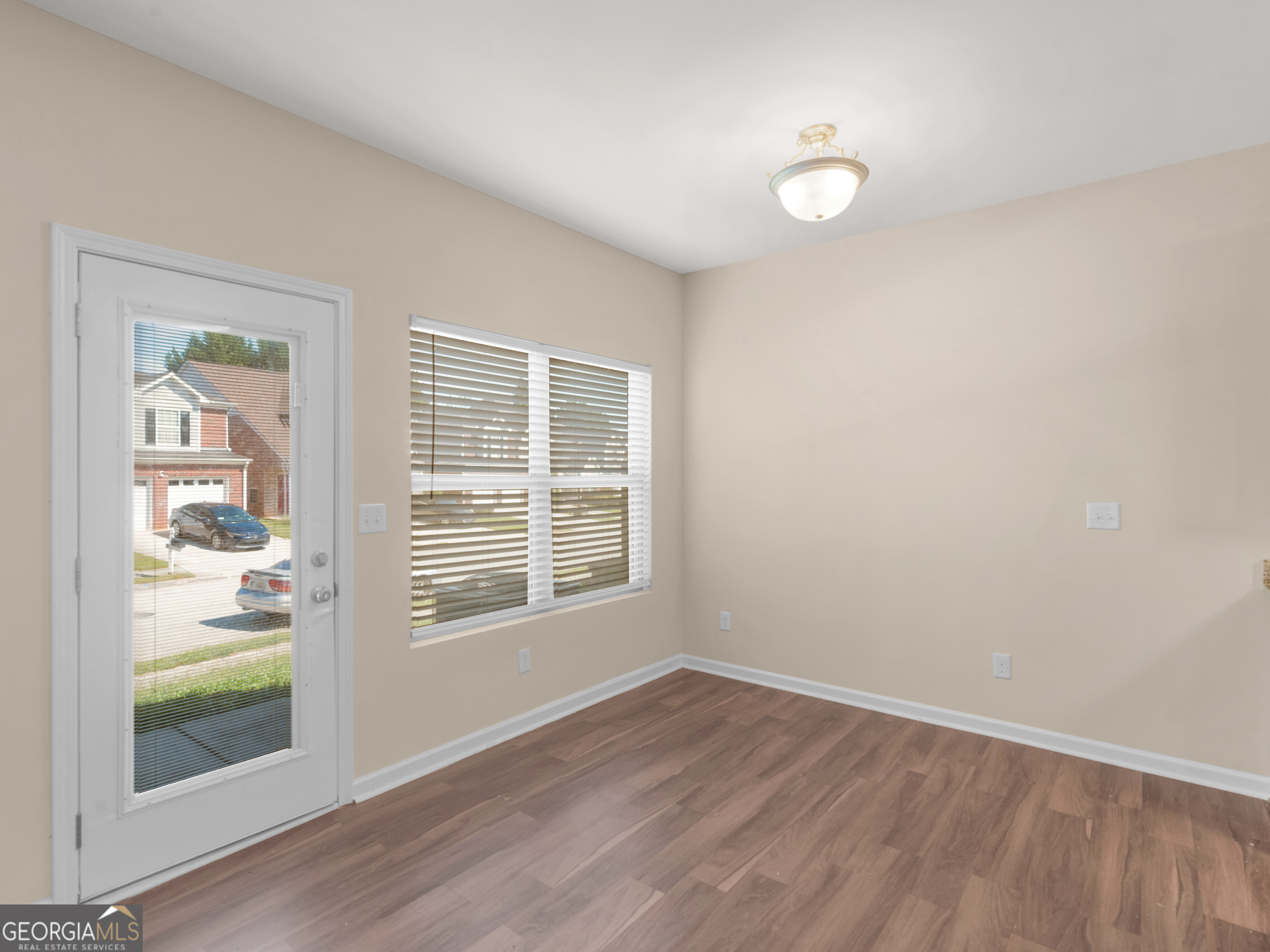 1244 Faye Court McDonough, GA 30253 - Photo 7 of 35 an empty room with wooden floor and windows