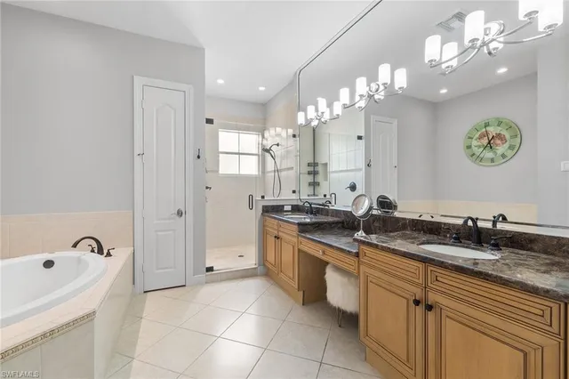 a large bathroom with a sink a large mirror and a shower