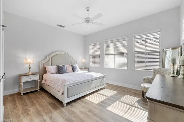 a bedroom with a bed and a large window