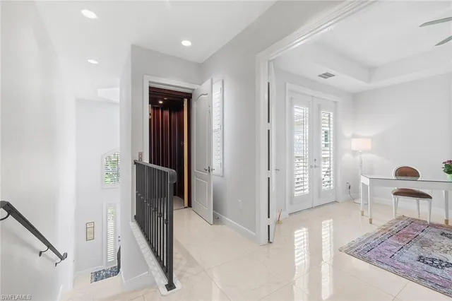 a view of a hallway with furniture and a livingroom