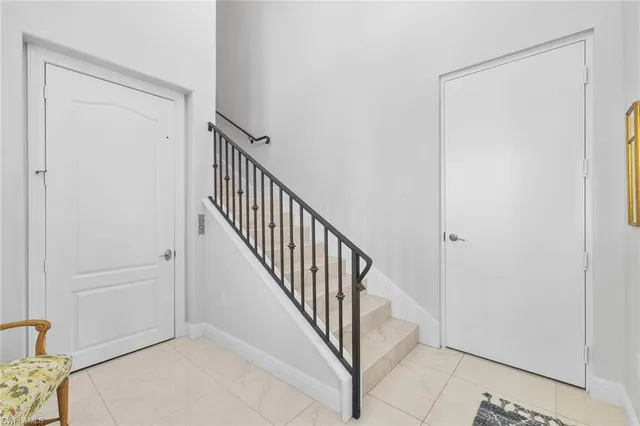 a view of a hallway with white walls and cabinet