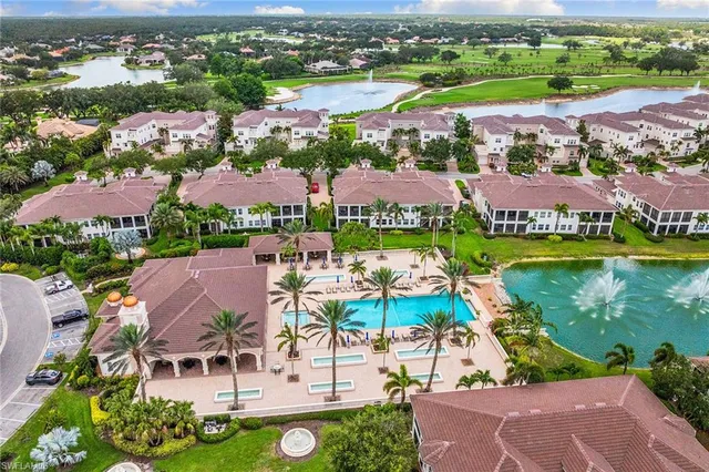 an aerial view of residential houses with outdoor space and river