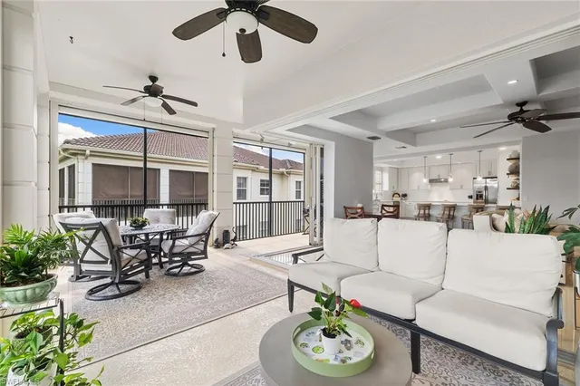a living room with furniture kitchen view and a window