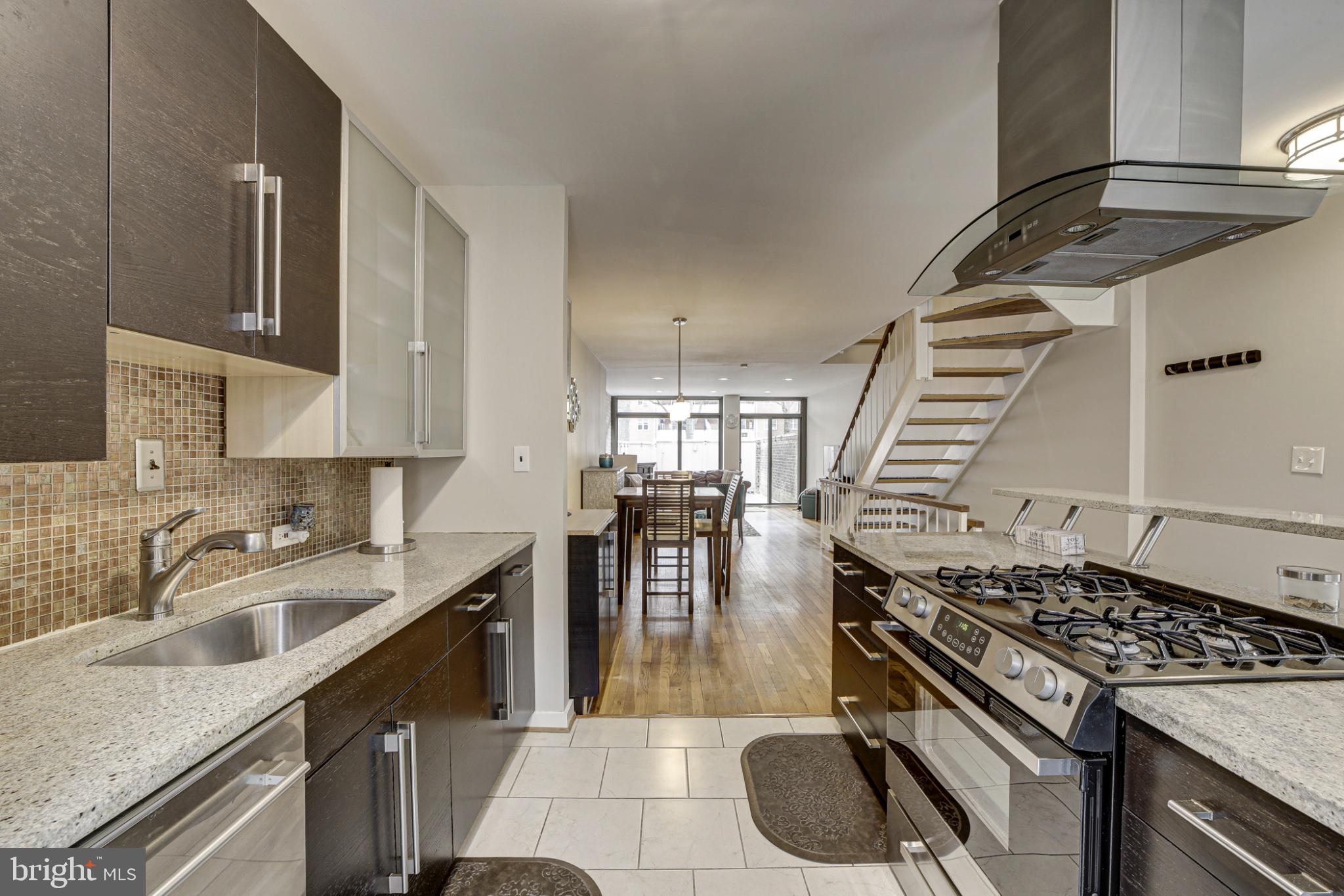 1273 Delaware Avenue Southwest Washington, DC 20024 - Photo 2 of 32 a kitchen with granite countertop a sink a stove and refrigerator