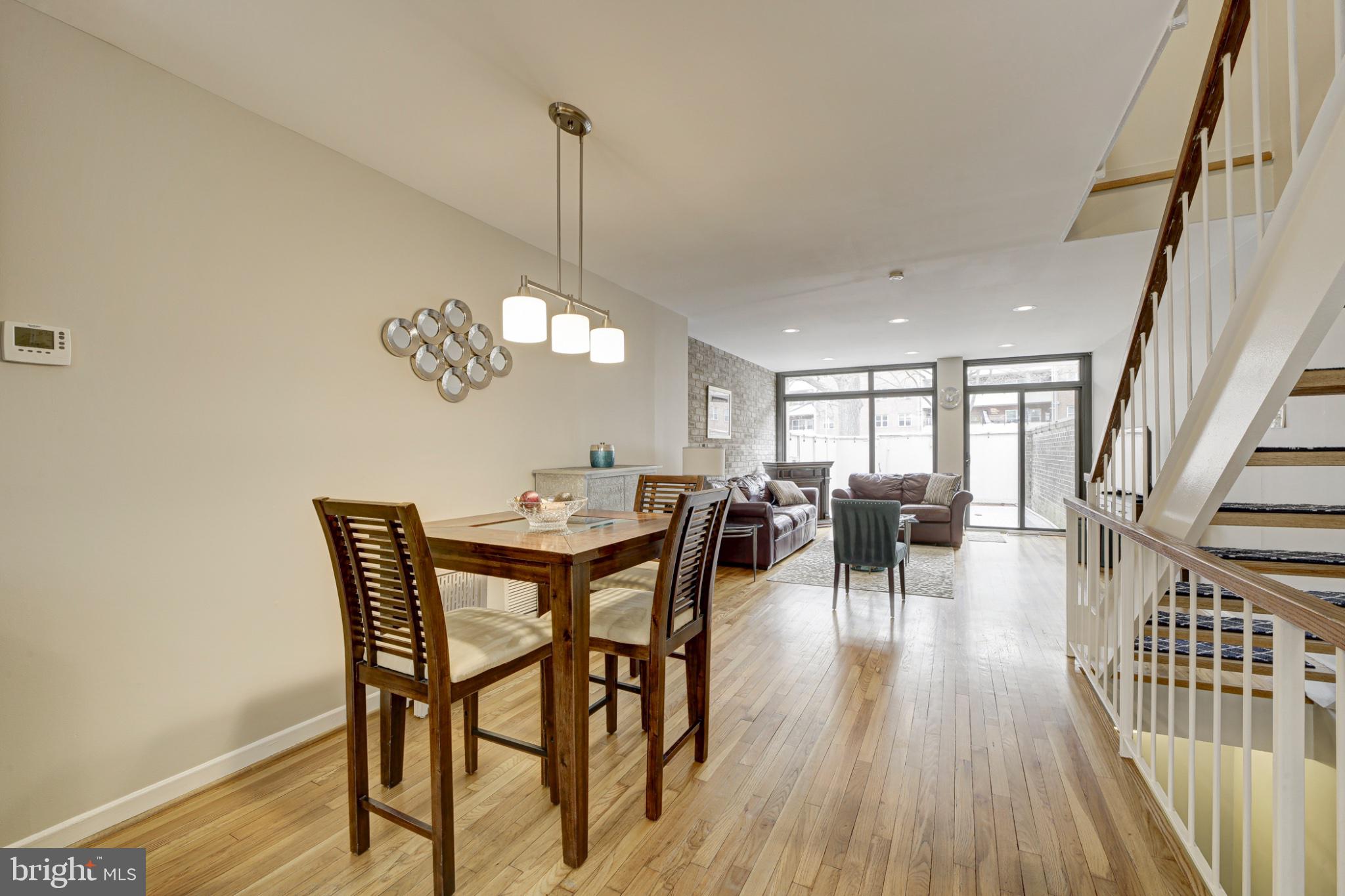 1273 Delaware Avenue Southwest Washington, DC 20024 - Photo 5 of 32 a view of a dining room and livingroom with furniture wooden floor a chandelier