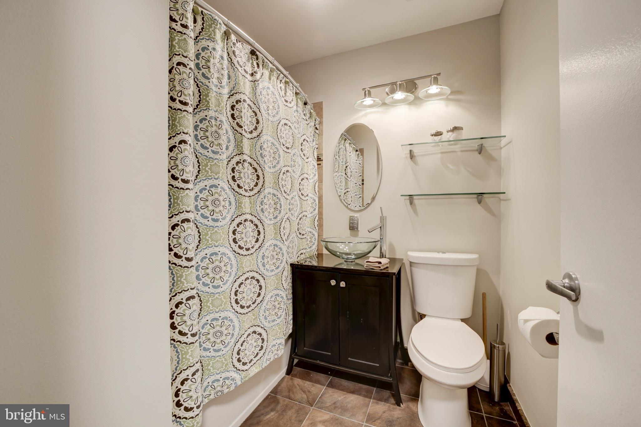 1273 Delaware Avenue Southwest Washington, DC 20024 - Photo 9 of 32 a white toilet sitting next to a shower curtain