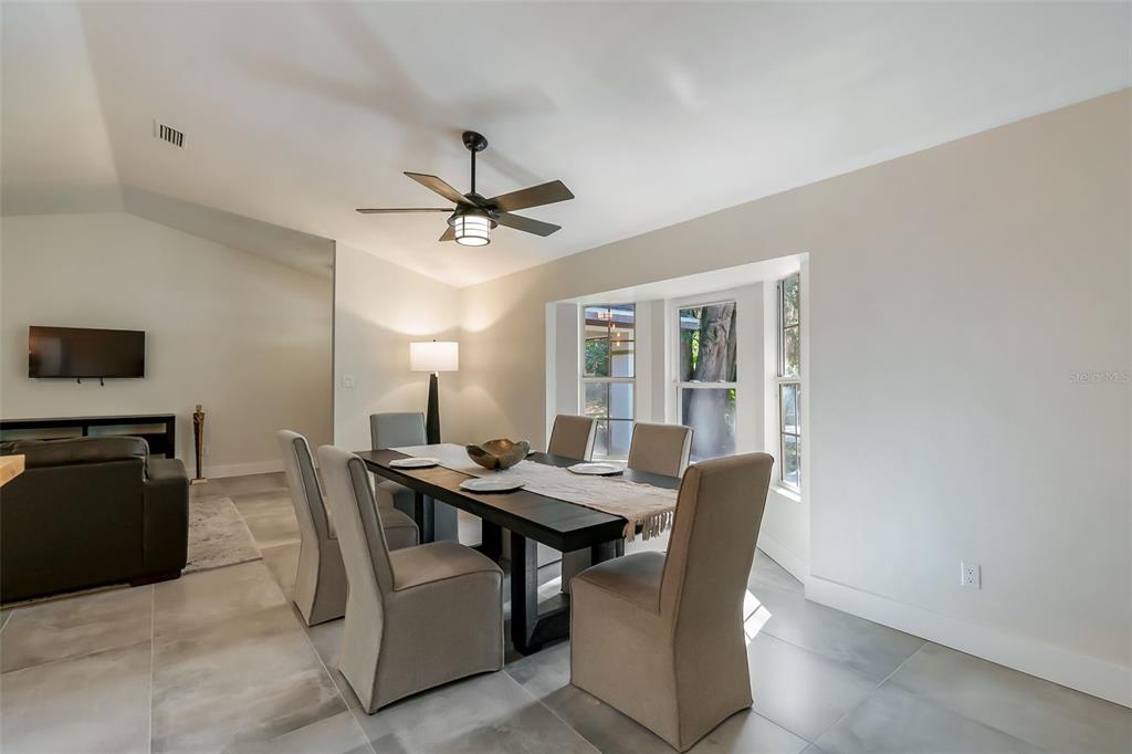 3222 Southwest 27th Street Gainesville, FL 32608 - Photo 15 of 42 a view of a dining room with furniture and a chandelier