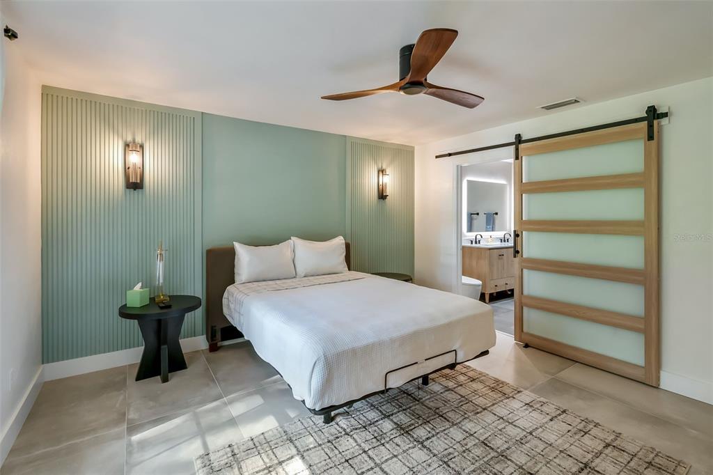 3222 Southwest 27th Street Gainesville, FL 32608 - Photo 18 of 42 a bedroom with a bed and a chandelier