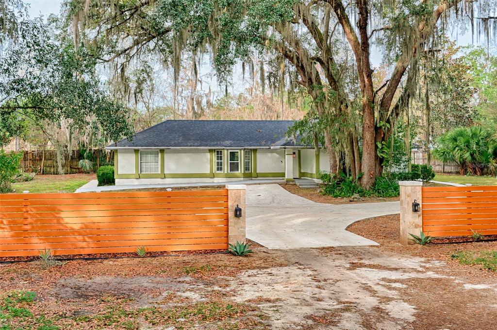 3222 Southwest 27th Street Gainesville, FL 32608 - Photo 2 of 42 a front view of a house with a yard