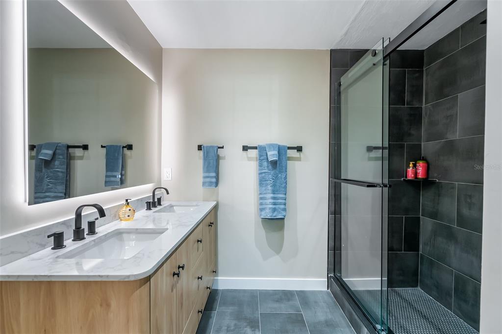 3222 Southwest 27th Street Gainesville, FL 32608 - Photo 21 of 42 a bathroom with a sink and a mirror