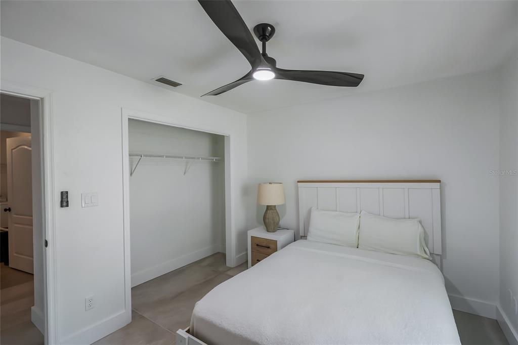 3222 Southwest 27th Street Gainesville, FL 32608 - Photo 24 of 42 a bedroom with a bed and a ceiling fan