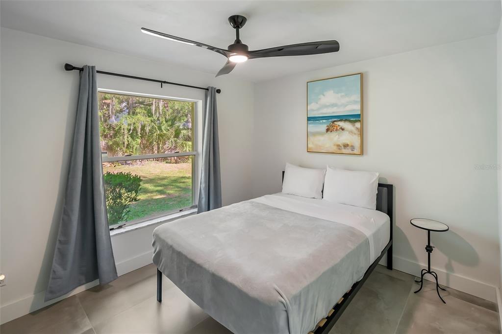 3222 Southwest 27th Street Gainesville, FL 32608 - Photo 26 of 42 a bedroom with a bed and a large window