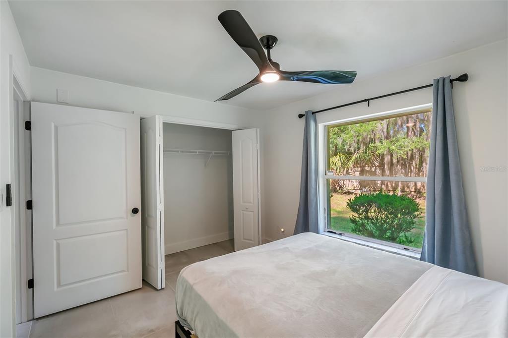 3222 Southwest 27th Street Gainesville, FL 32608 - Photo 27 of 42 a bedroom with a large bed and a large window