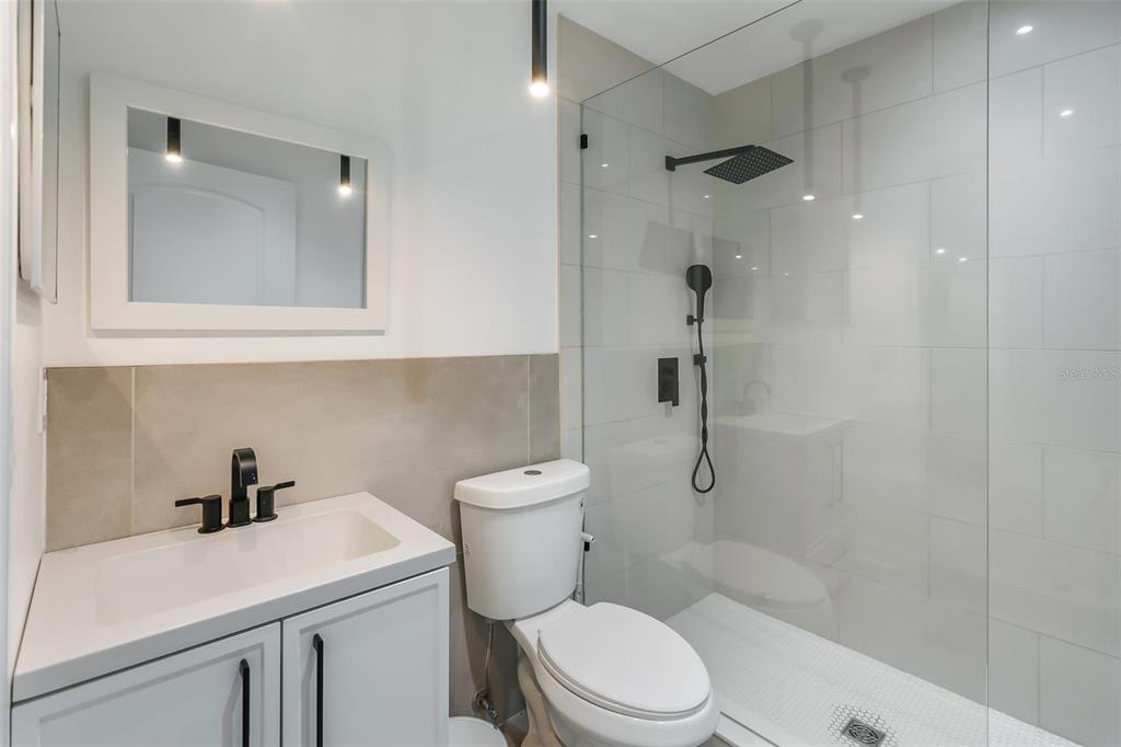 3222 Southwest 27th Street Gainesville, FL 32608 - Photo 29 of 42 a bathroom with a toilet sink and shower