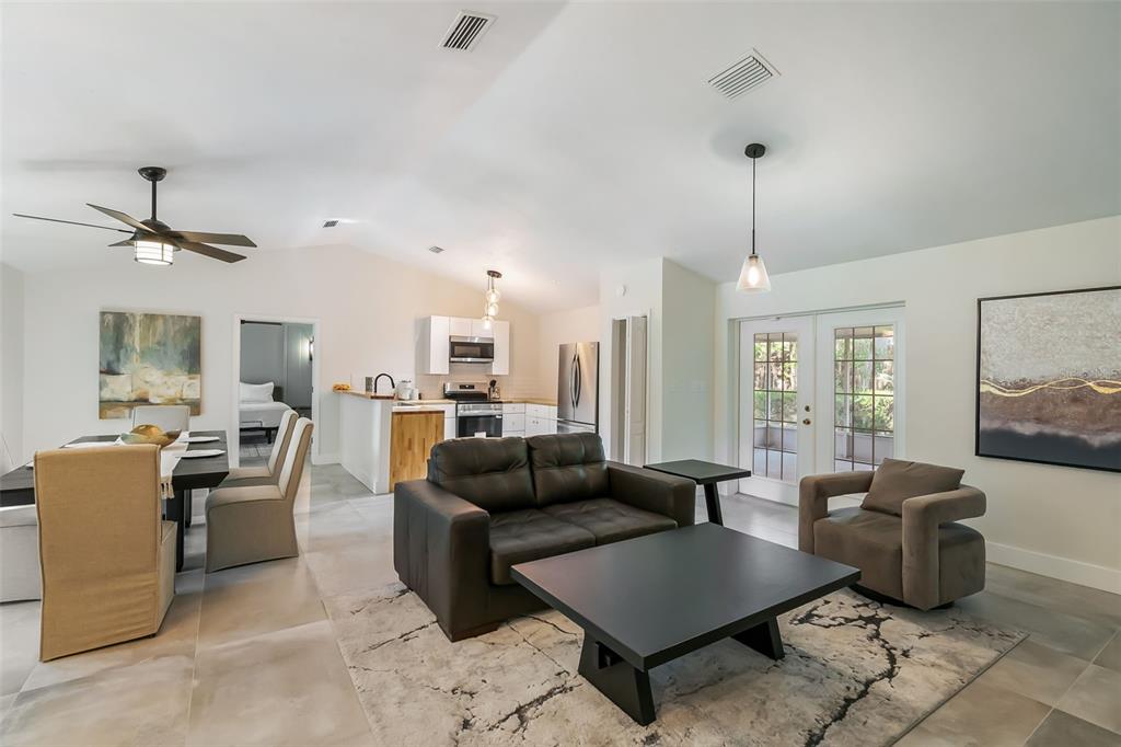 3222 Southwest 27th Street Gainesville, FL 32608 - Photo 3 of 42 a living room with furniture and a chandelier