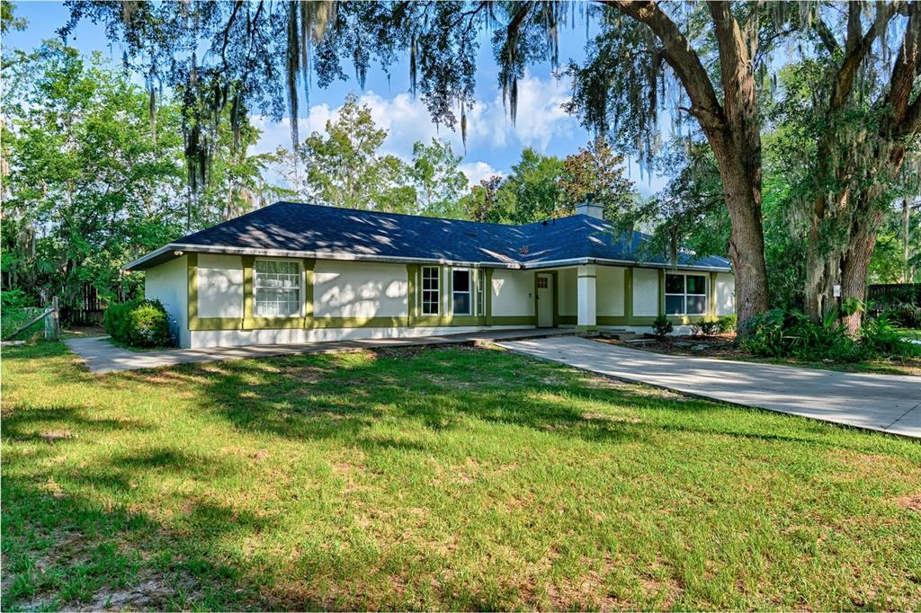 3222 Southwest 27th Street Gainesville, FL 32608 - Photo 33 of 42 a front view of a house with a yard table and chairs