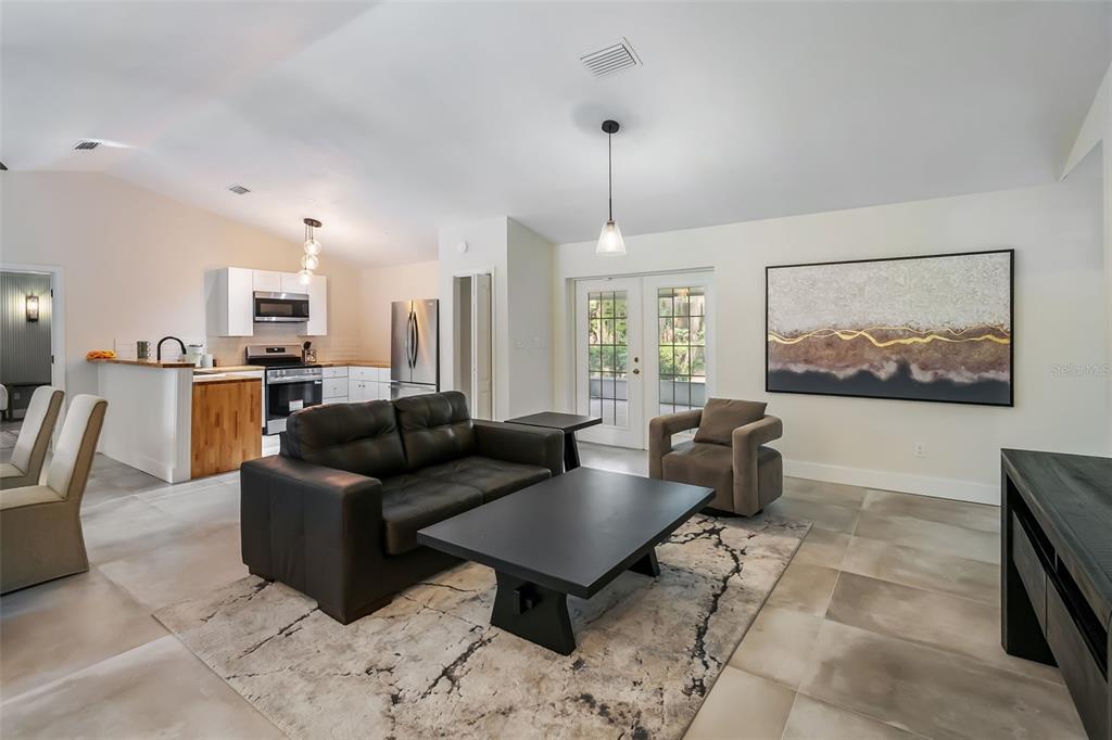 3222 Southwest 27th Street Gainesville, FL 32608 - Photo 5 of 42 a living room with furniture a rug and a chandelier