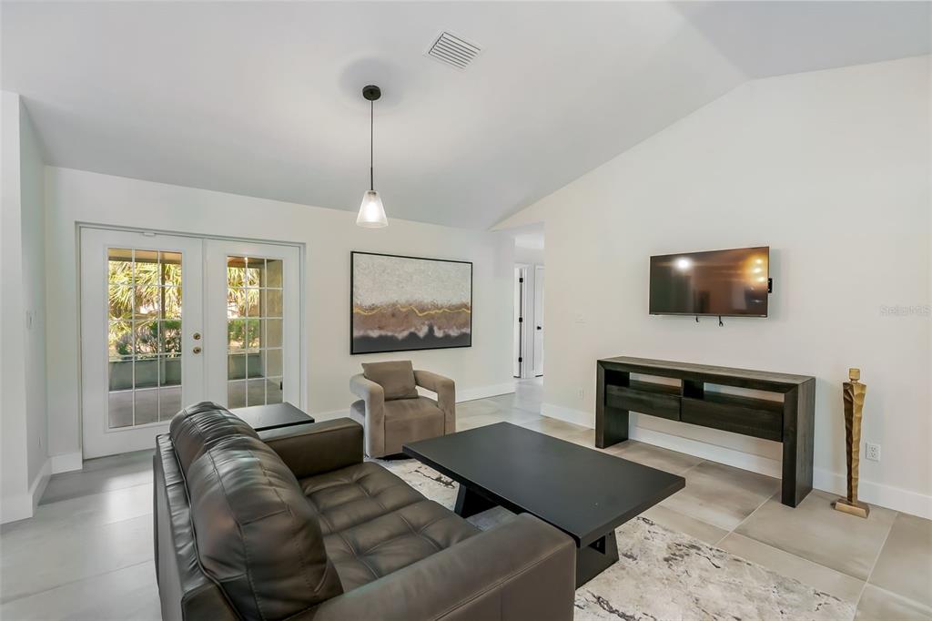 3222 Southwest 27th Street Gainesville, FL 32608 - Photo 6 of 42 a living room with furniture and a flat screen tv