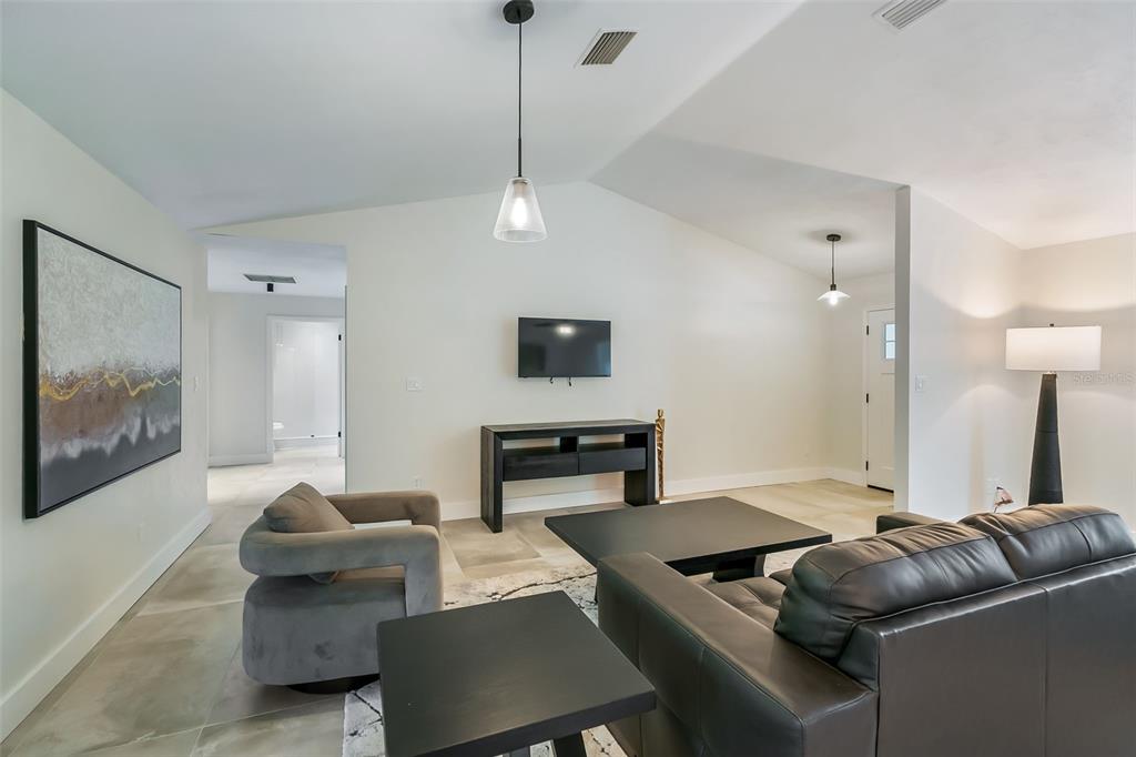 3222 Southwest 27th Street Gainesville, FL 32608 - Photo 7 of 42 a living room with furniture and a flat screen tv