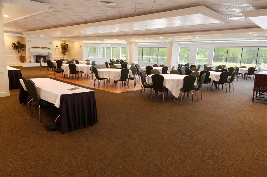 3637 Downfield Place, Unit 402 New Port Richey, FL 34655 - Photo 33 of 39 a large room with lots of tables a chandelier and couches