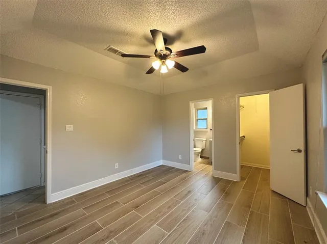 a view of an empty room and wooden floor