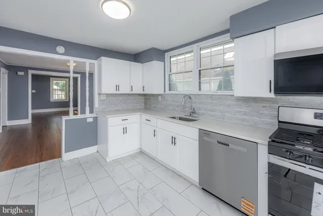 a kitchen with cabinets appliances and a window