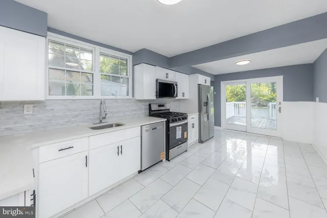 a kitchen with granite countertop a sink and a stove top oven