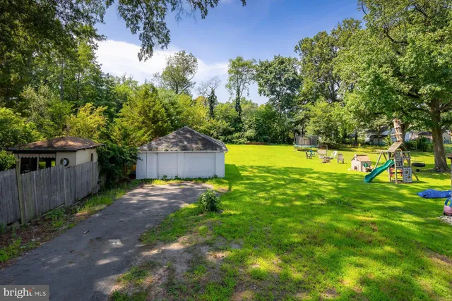a view of a backyard with wooden fence