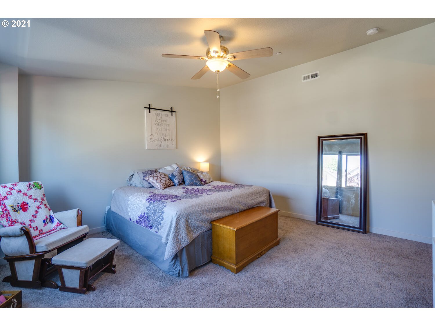 129 North 44th Place Ridgefield, WA 98642 - Photo 22 of 27 a bedroom with a bed and a chandelier
