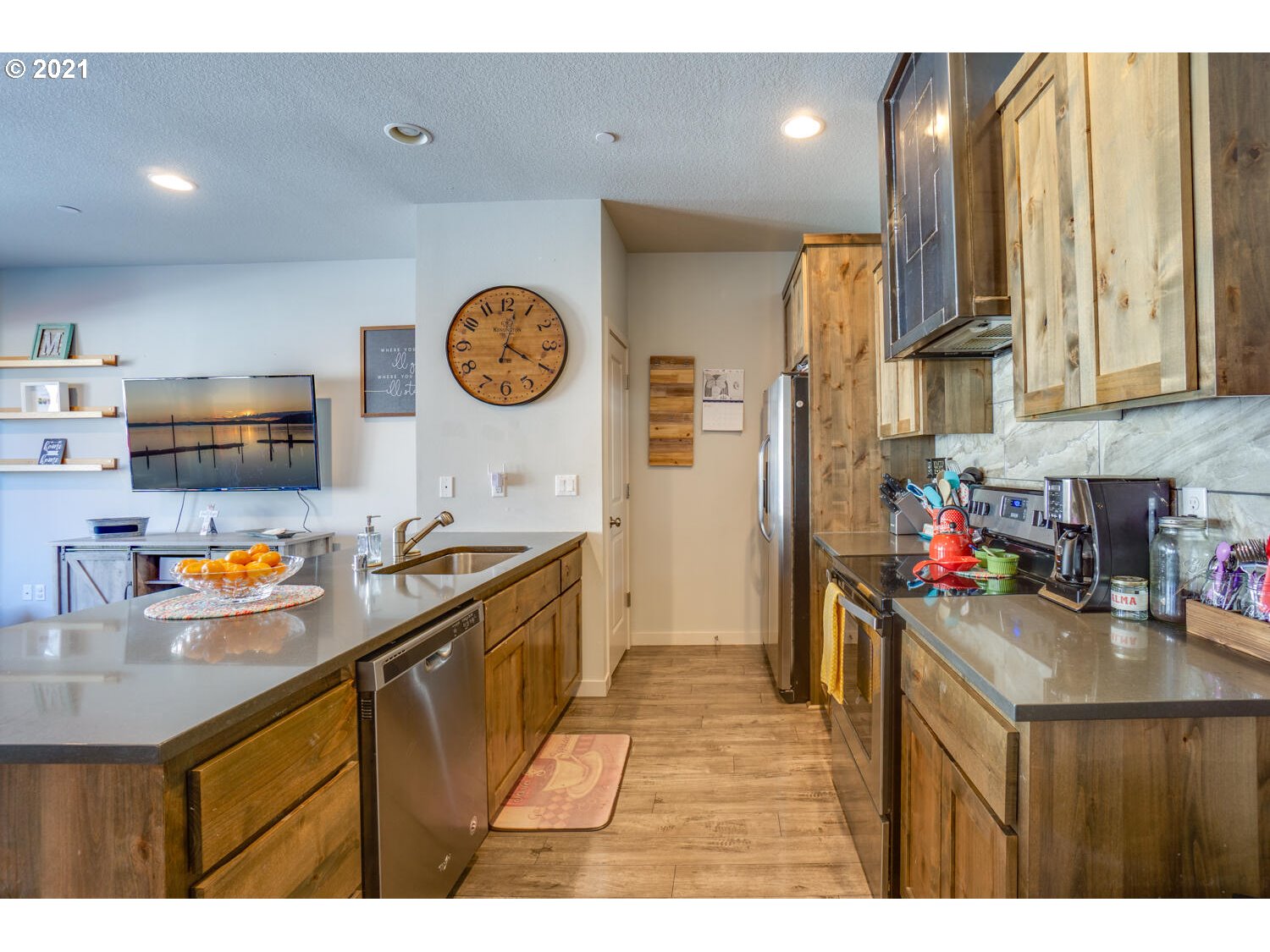 129 North 44th Place Ridgefield, WA 98642 - Photo 8 of 27 a kitchen that has a lot of cabinets a sink and wooden floor