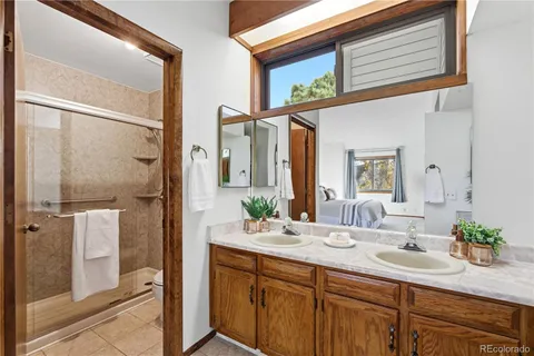 a bathroom with a double vanity sink and mirror